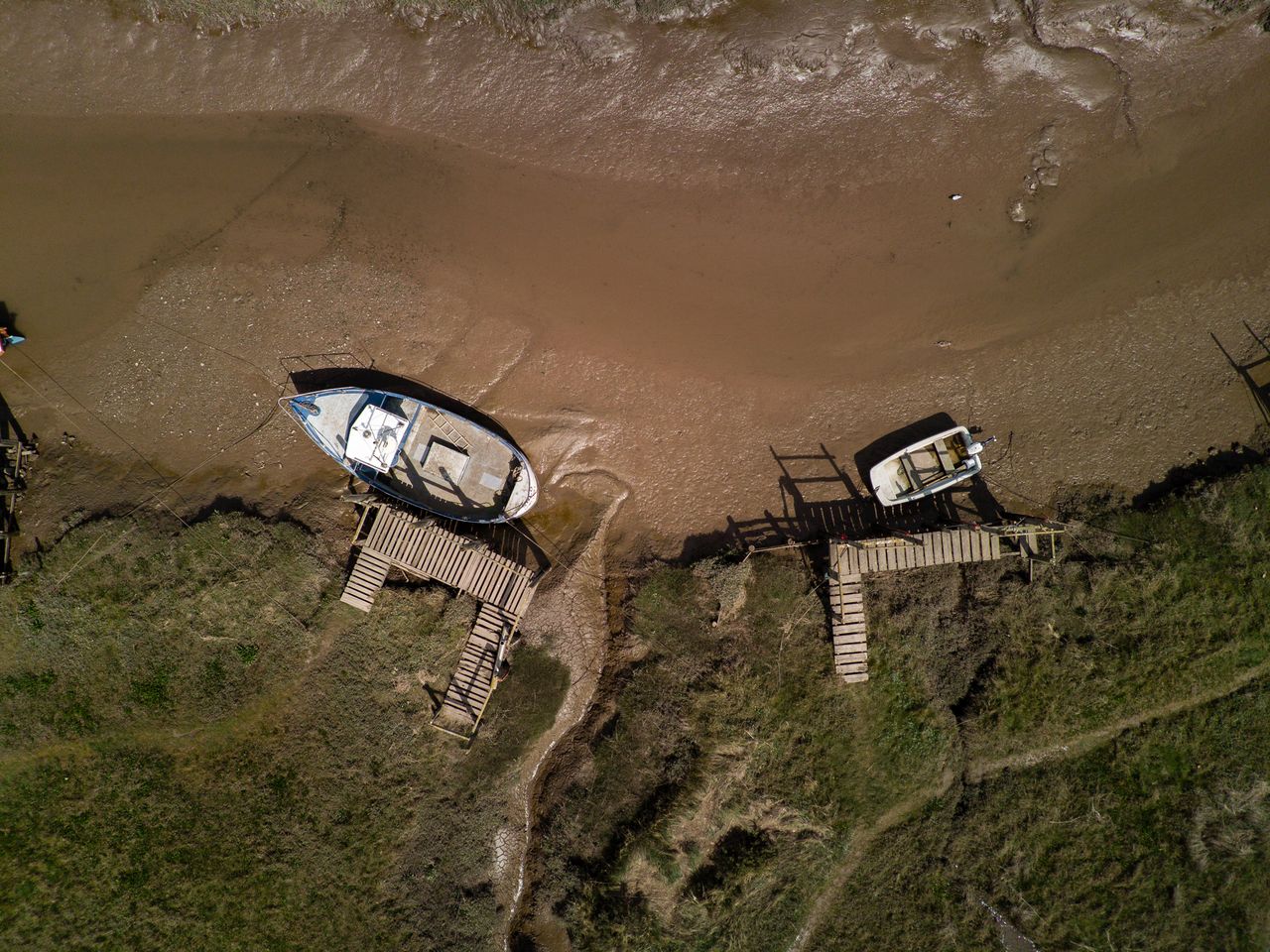 An aerial view of two moored boats