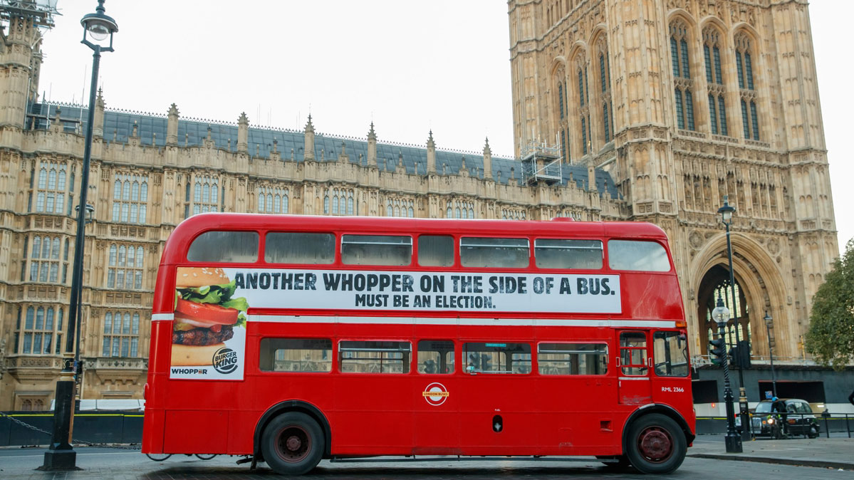 Bus outside Parliament with Burger King  ad