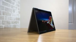 A photograph of the Lenovo ThinkPad X1 Titanium Yoga in tent mode