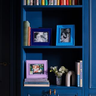 Navy blue shelves with multi coloured bobbin frames