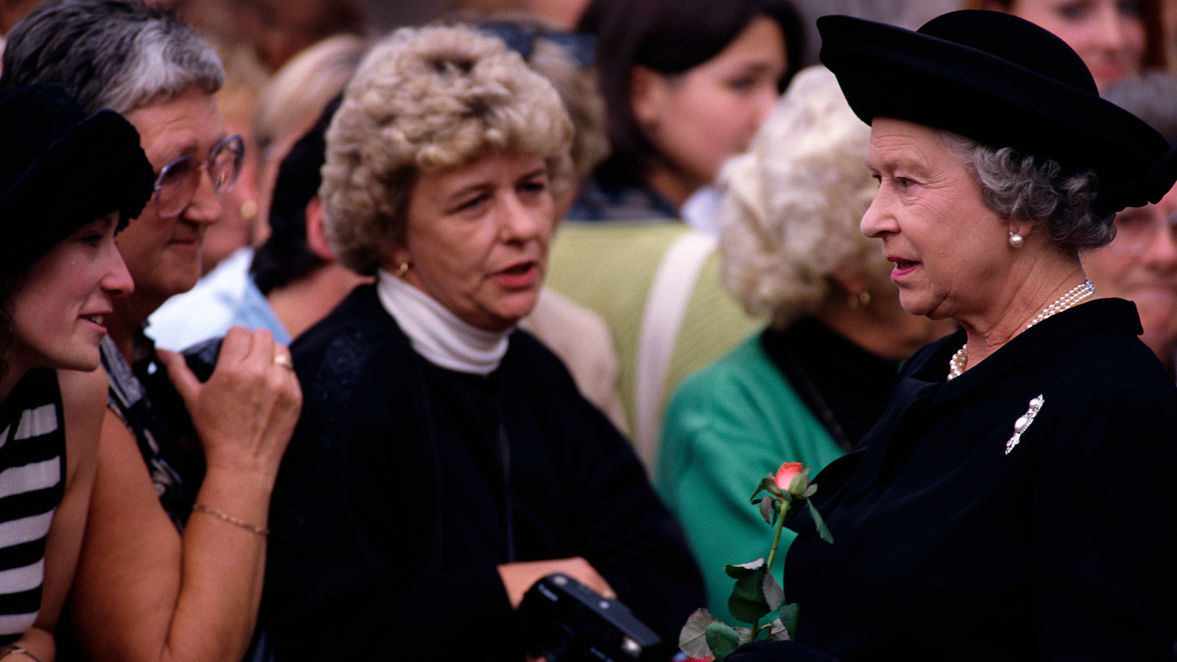 Queen Elizabeth II greets mourners waiting in line to sign the condolence book for Princess Diana