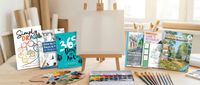 art books and an easel on a table