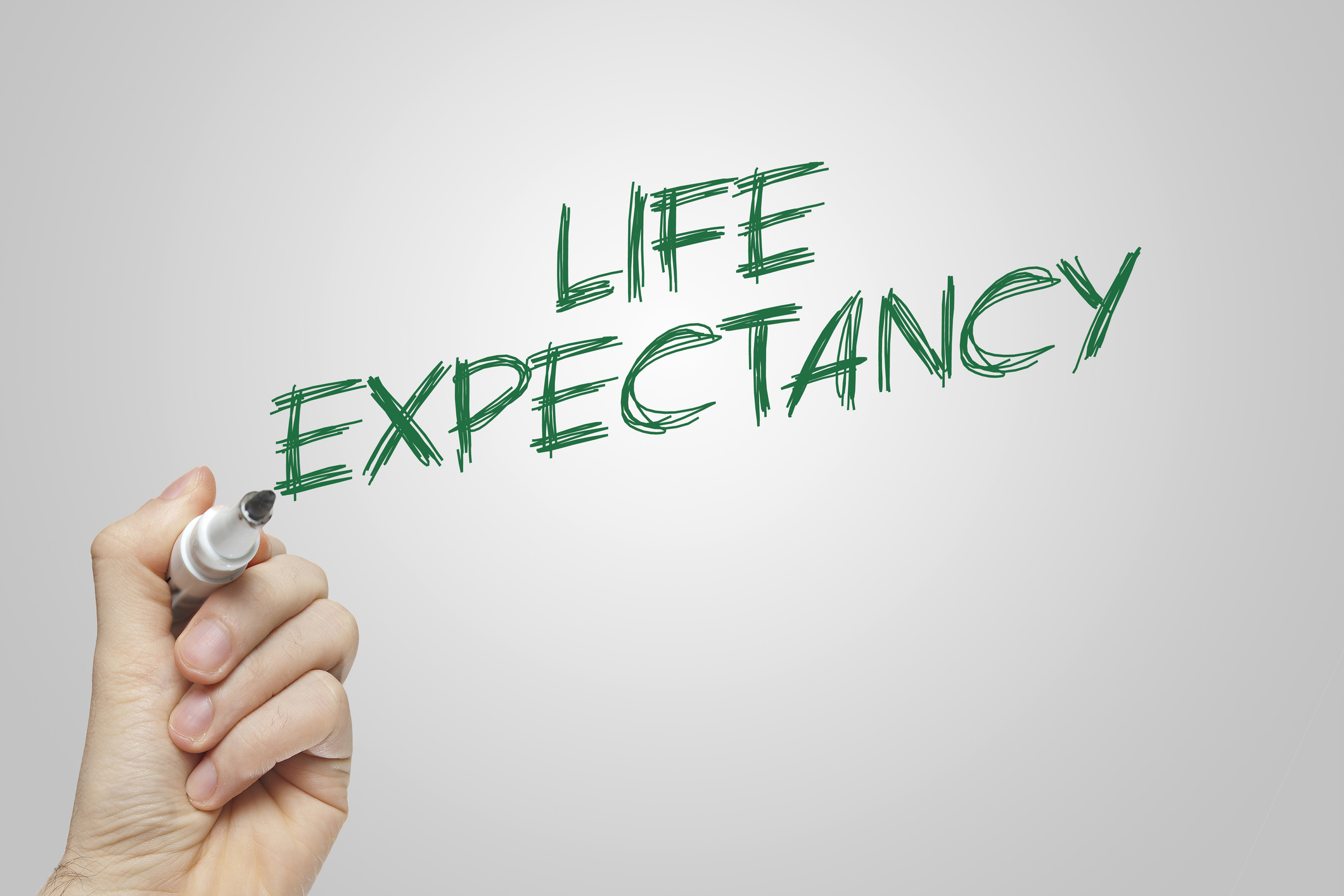 Hand writing life expectancy on grey background
