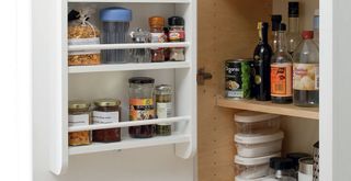 kitchen cabinet open to show neatly organzied shelves and door unit to create extra storage space