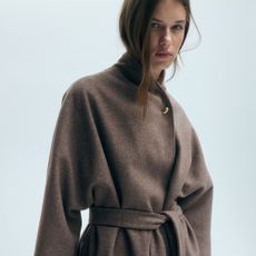 Model wears brown wrap felt coat