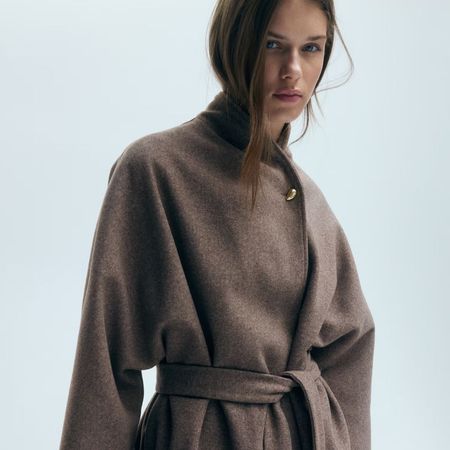 Model wears brown wrap felt coat