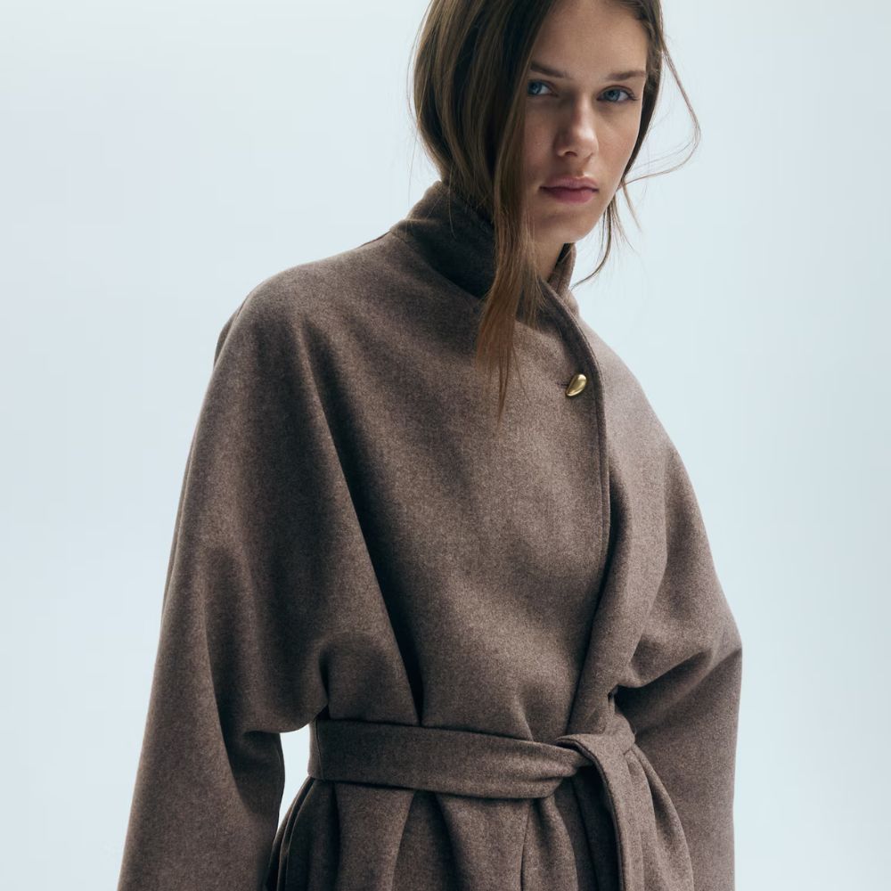 Model wears brown wrap felt coat