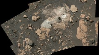 An image of rocks on Mars. Central rocks have holes cut out, from which Perseverance collected samples.