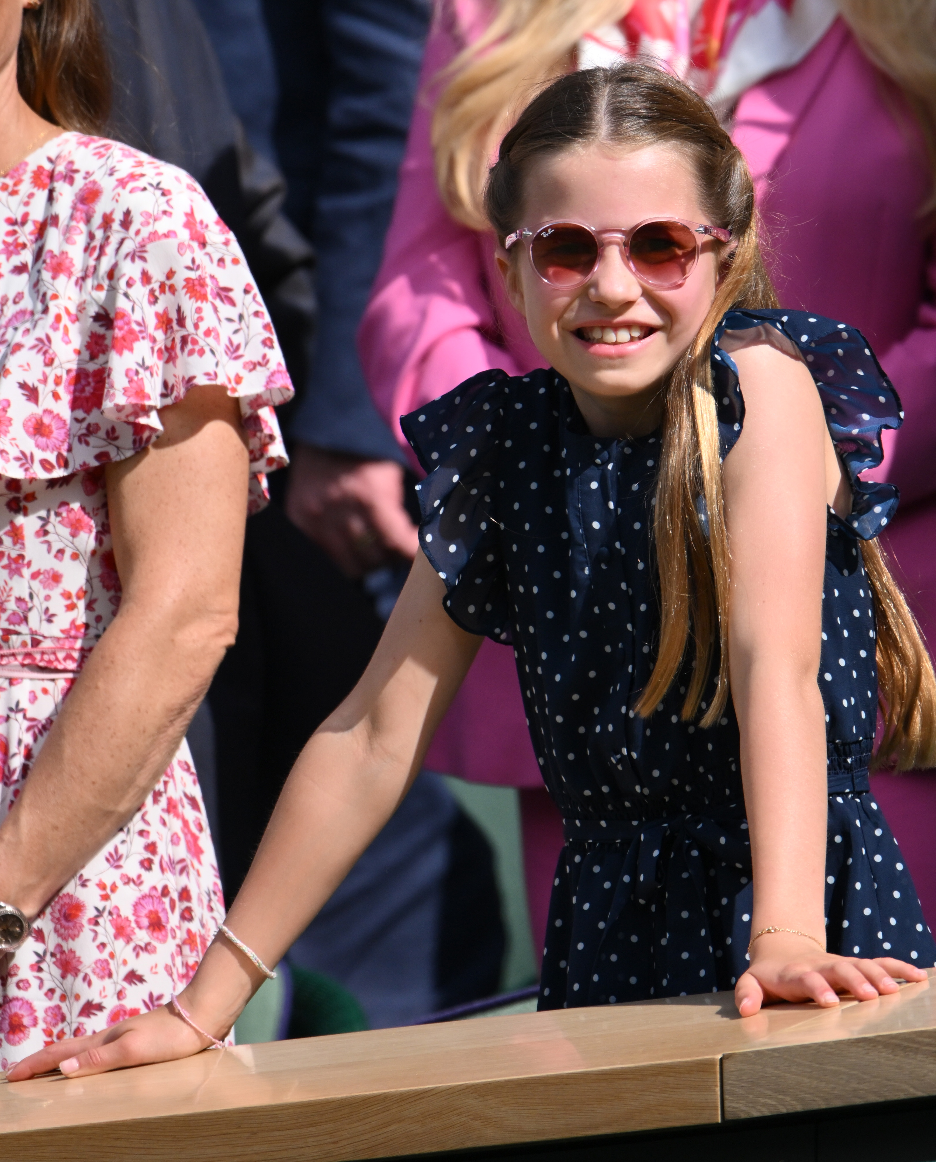 Princess Charlotte wearing pink sunglasses at Wimbledon and smiling