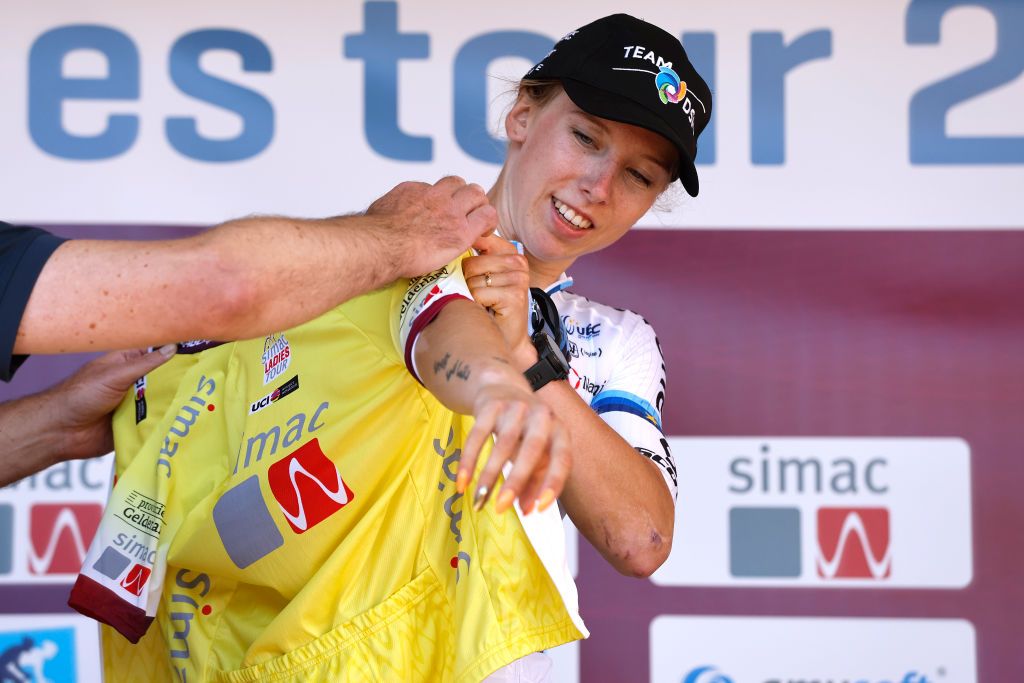 GENNEP NETHERLANDS SEPTEMBER 01 Lorena Wiebes of Netherlands and Team DSM puts on the Yellow leader jersey at podium during the 25th Simac Ladies Tour 2022 Stage 3 a 1391km stage from Gennep to Gennep SLT2022 UCIWWT on September 01 2022 in Gennep Netherlands Photo by Bas CzerwinskiGetty Images
