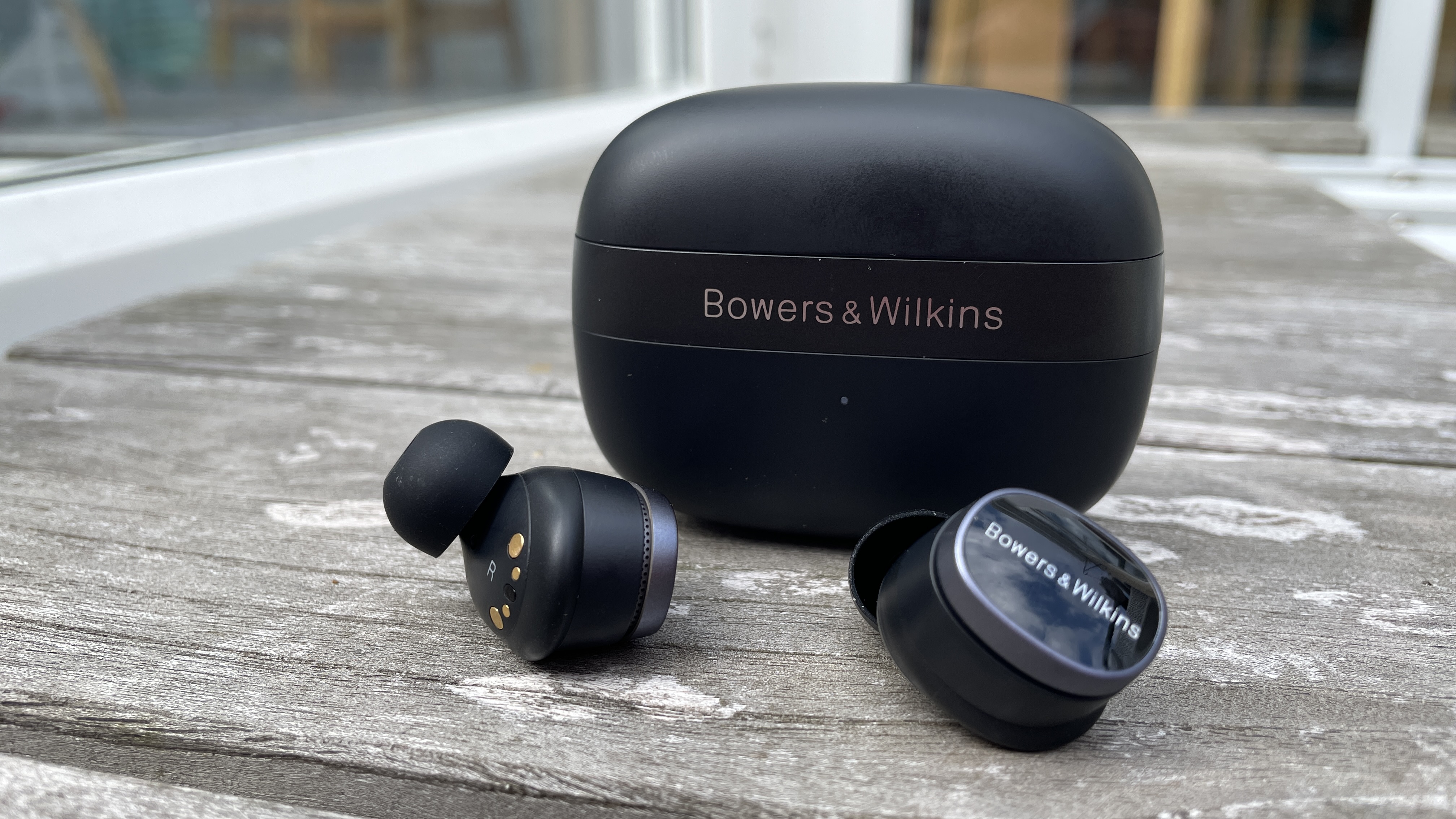 Bowers & Wilkins Pi8 against grey wood background