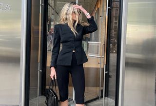 Eliza Huber wearing a fitted black blazer and black Donni capri pants.