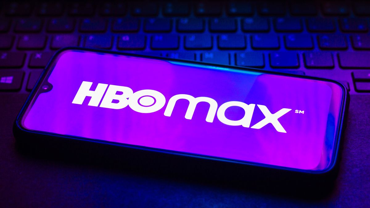 The HBO Max logo on a phone on top of a keyboard