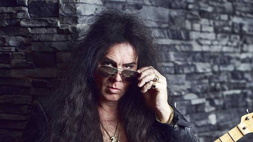 Yngwie Malmsteen looking over the top of his sunglasses