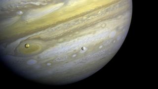 Jupiter and two of its moons — Io, to the left, and Europa — as seen by Voyager 1 on Feb. 13, 1979.