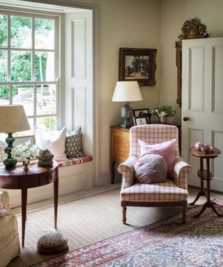 A country style living room picture with antique rug and armchair