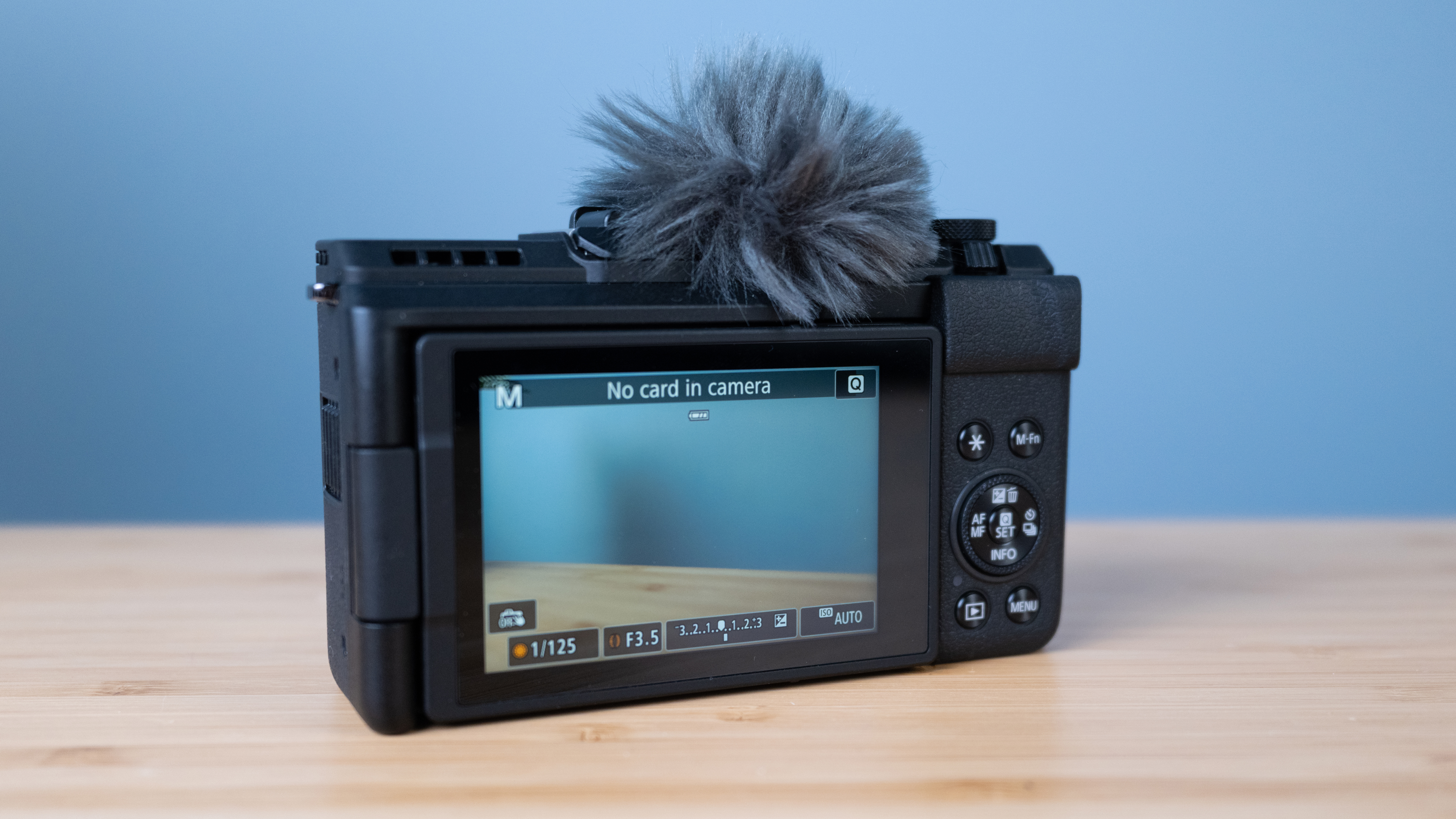 A black Canon PowerShot V1 compact vlogging camera