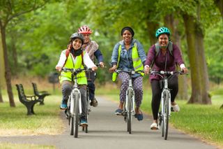 Cycle Sisters riding in a park together