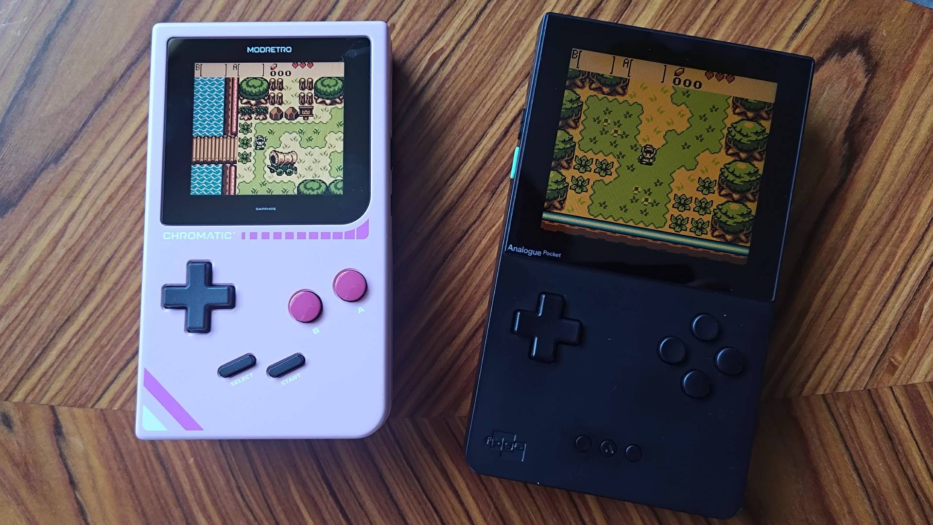 Modretro Chromatic next to Analogue Pocket on woodgrain table with Zelda: Oracle of Seasons/Ages gameplay on screens.