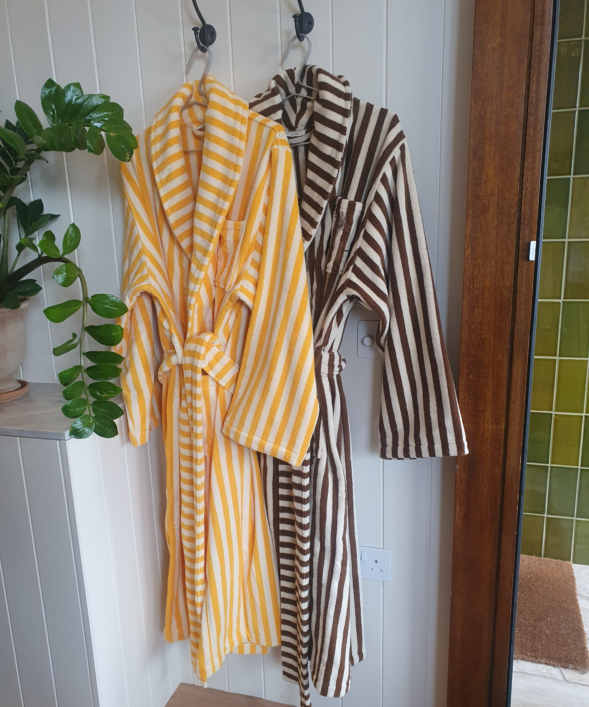 A set of striped bathrobes from the H&M Home x Palm Heights collection at the press preview of the range