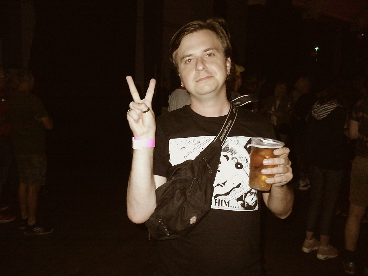Sample image taken with Camp Snap 2 digital compact camera, showing man holding pint of lager in a dark room, lit by LED flash