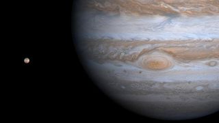 NASA's Cassini spacecraft captures Jupiter along with Io, one of the planet's at least 92 moons.