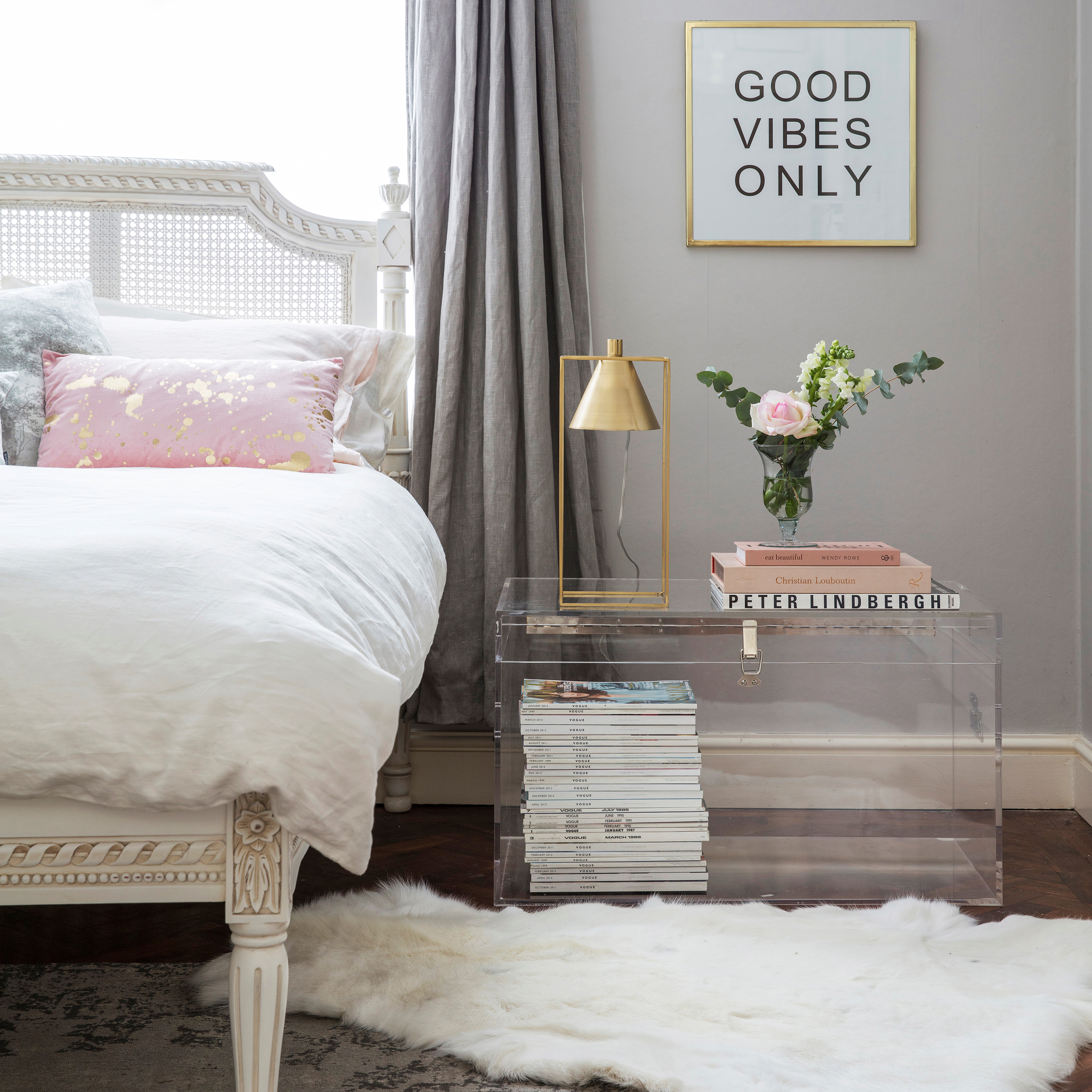 transparent acrylic storage trunk used as bedside table