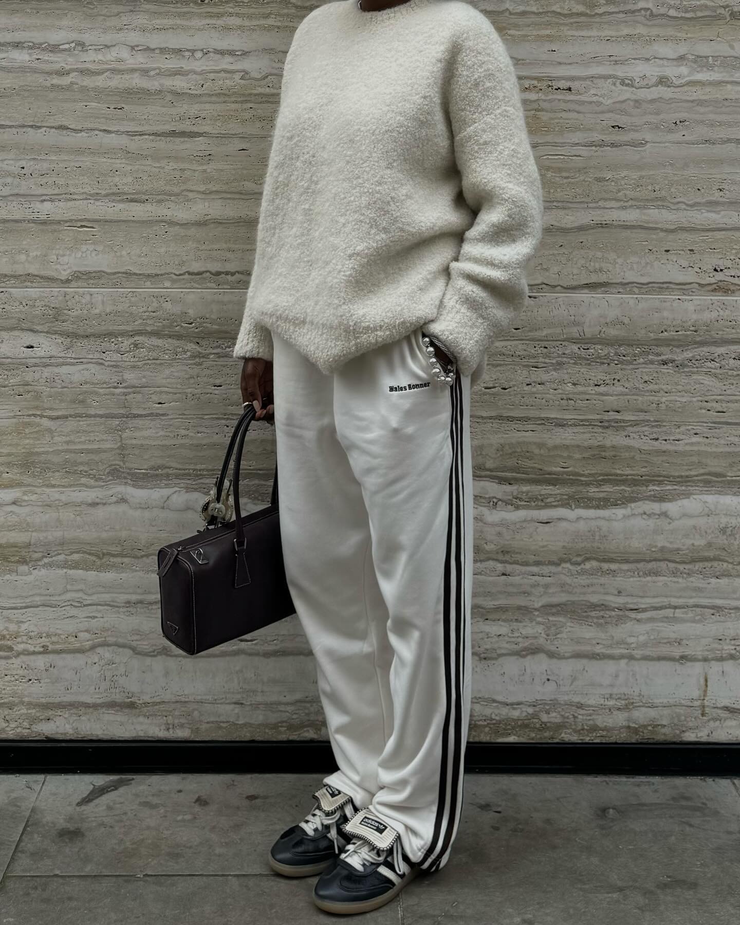 Influencer @daniellejinadu wears a cream jumper with cream track pants and black Wales Bonner X Adidas trainers.