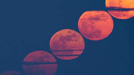 A composite view showing a diagonal line of cloud-streaked red full moons rising through a dark evening sky.