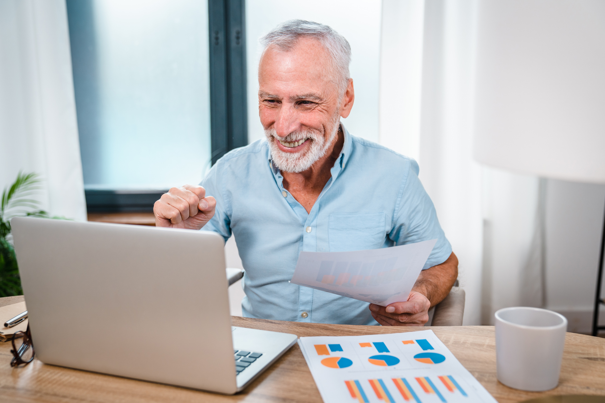 a happy man going over financial reports