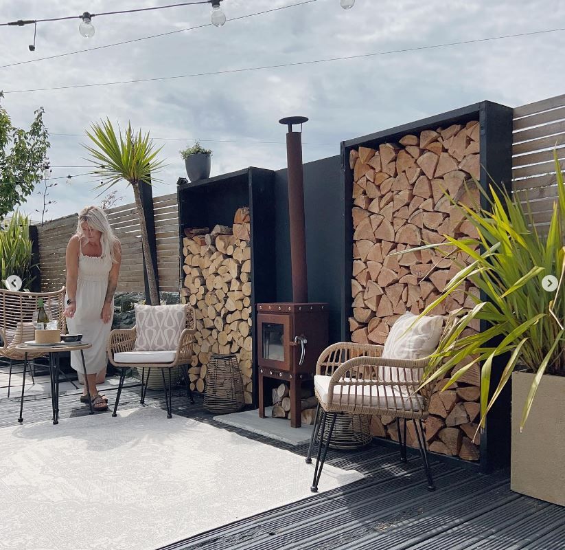 An outdoor area with neatly stacked logs
