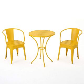 A yellow metal bistro set with a table and two chairs