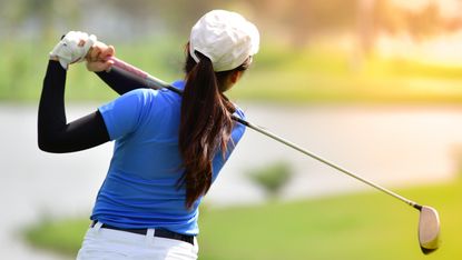A generic image of a female golfer taking a shot