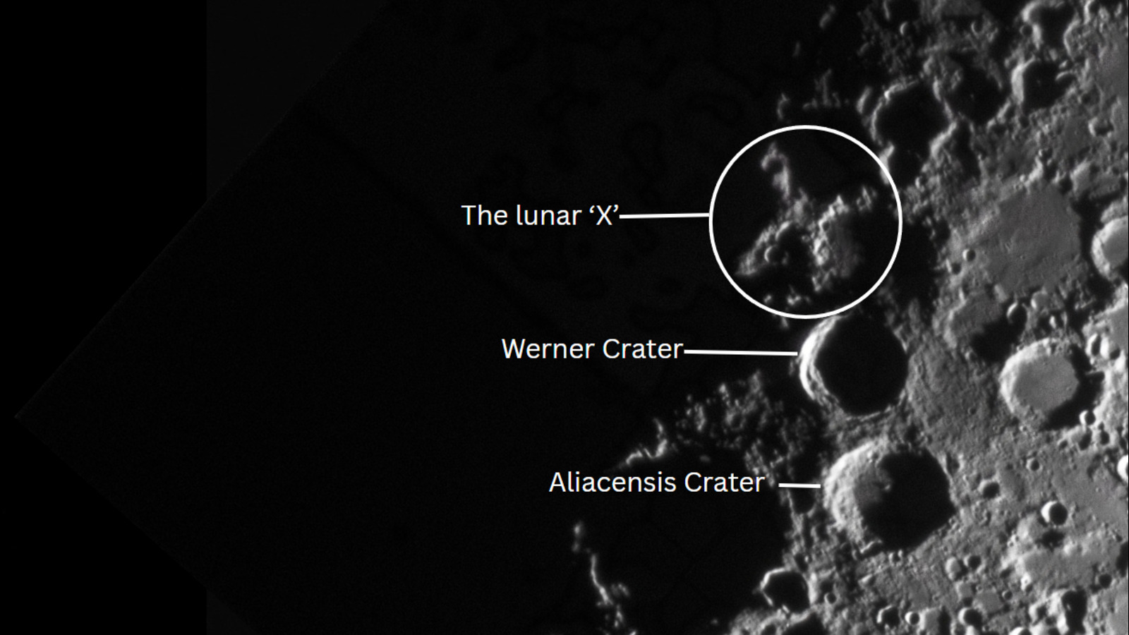 A bright 'X'-like shape can be seen on the lunar surface surrounded by craters. The right half of the lunar surface is bathed in sunlight, while the left is in shadows, picking out raised sections of the lunar terrain.