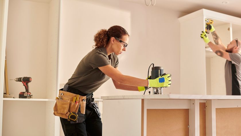 A carpenter routing a kitchen worktop