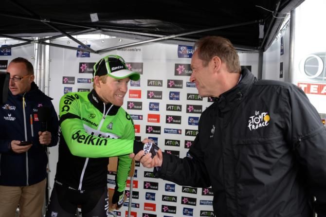 Tour de France race director Christian Prudhomme shakes Lars Pettter Nordhaug's hand after his win