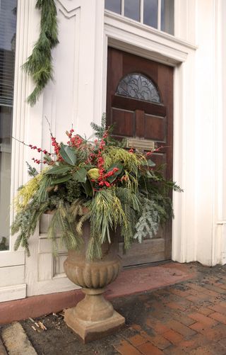 branches and berries in an outdoor urn