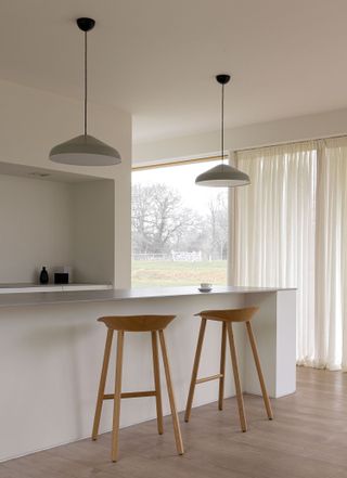 A kitchen with long, cascading curtains