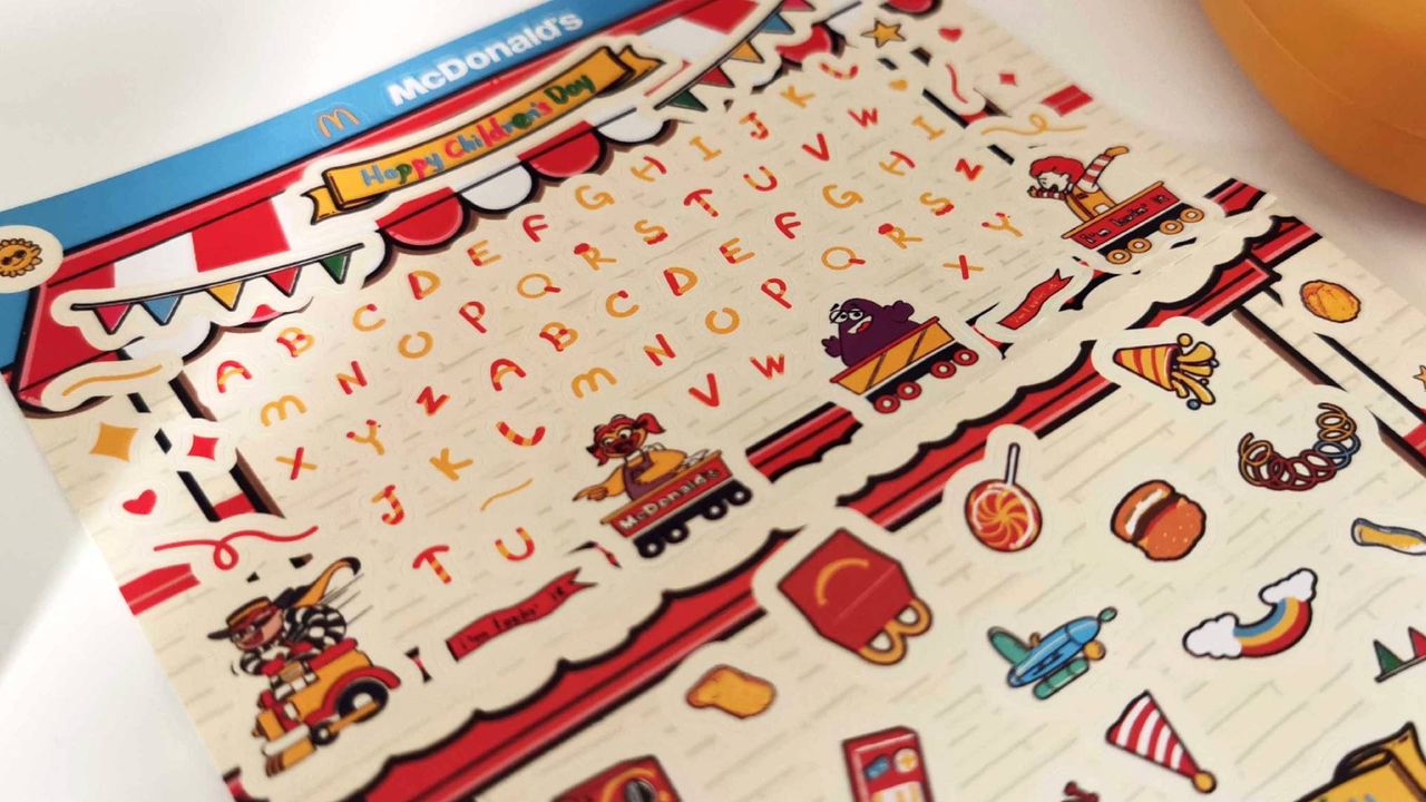 Closeup of Mcdonalds Mcnugget handheld extra stickers with Grimace and characters in view