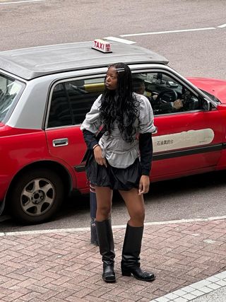 woman wearing bubble mini skirt with knee-high moto boots