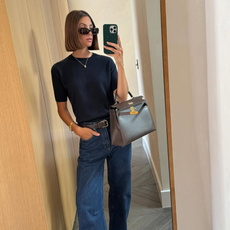 woman wearing dark wash bootcut jeans fall 2025