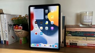An Apple iPad Air 5 next to some books