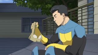 Mark Grayson sits as he holds his superhero mask in Invincible season 2