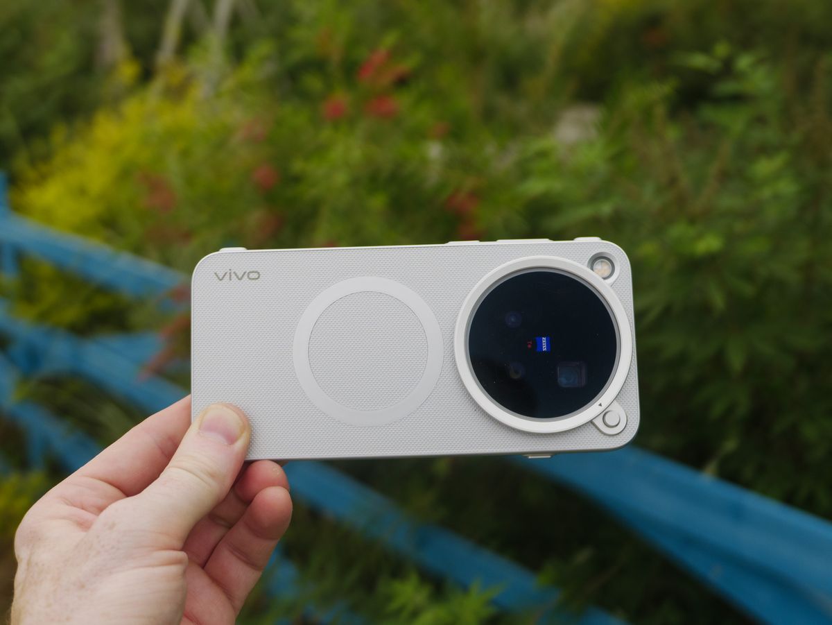The Vivo X500 Pro Max phone in user's hand, in its dedicated case for magnetic accessories such as Vivo's selfie screen