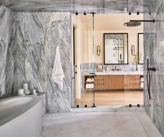 Bathroom with gray marble walls and view to vanity unit