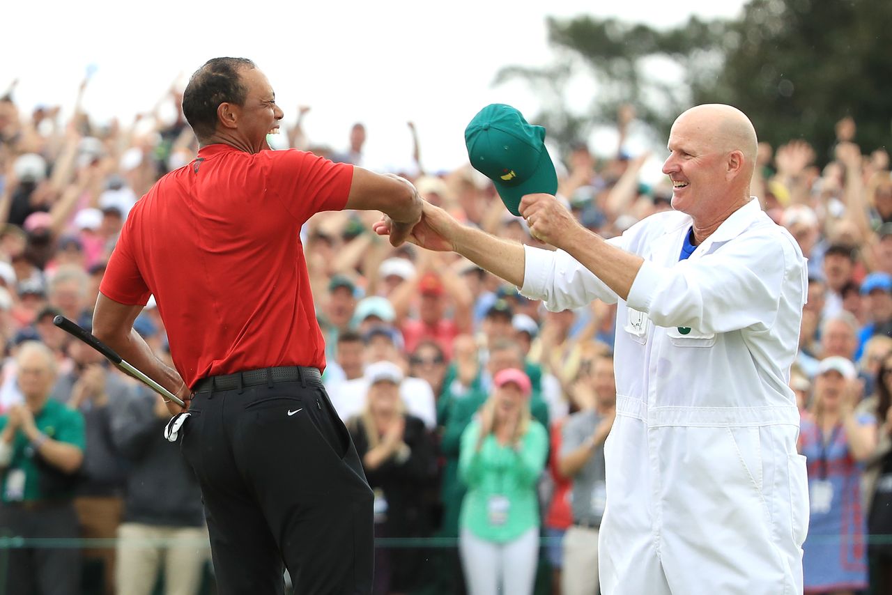 Tiger Woods and Joe LaCava celebrate on the 18th green