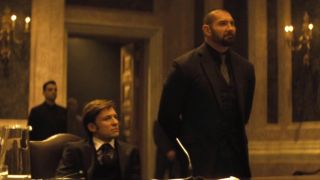 Benito Sagredo sits with Dave Bautista standing next to him in Spectre.