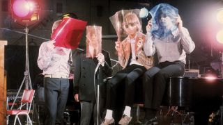 A photograph of the Beatles with coloured films held over their faces