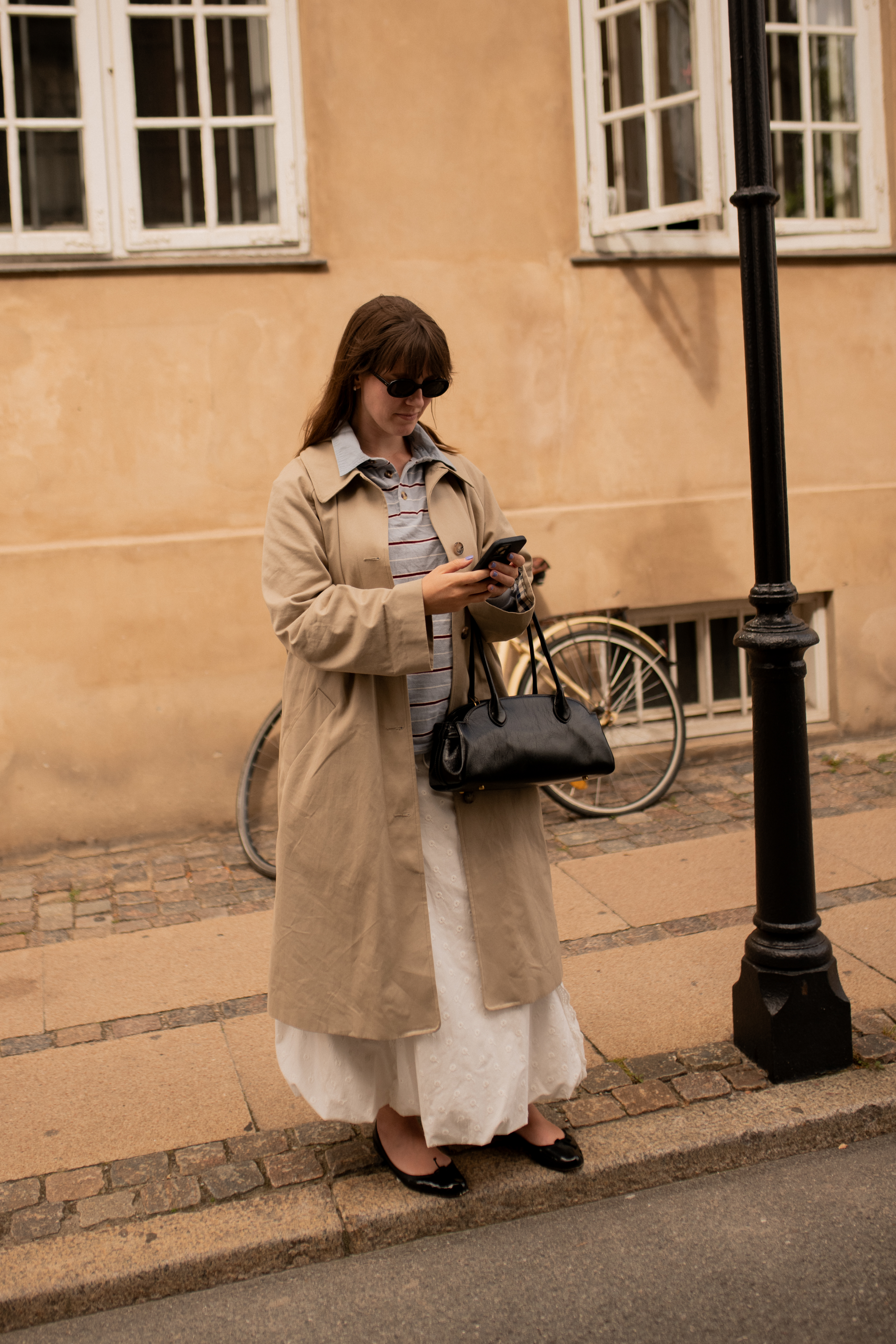 Halie LeSavage at Copenhagen Fashion Week wearing a bubble skirt and a trench coat