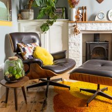 A 70s-style living room with a leather swivel chair with a matching footstool